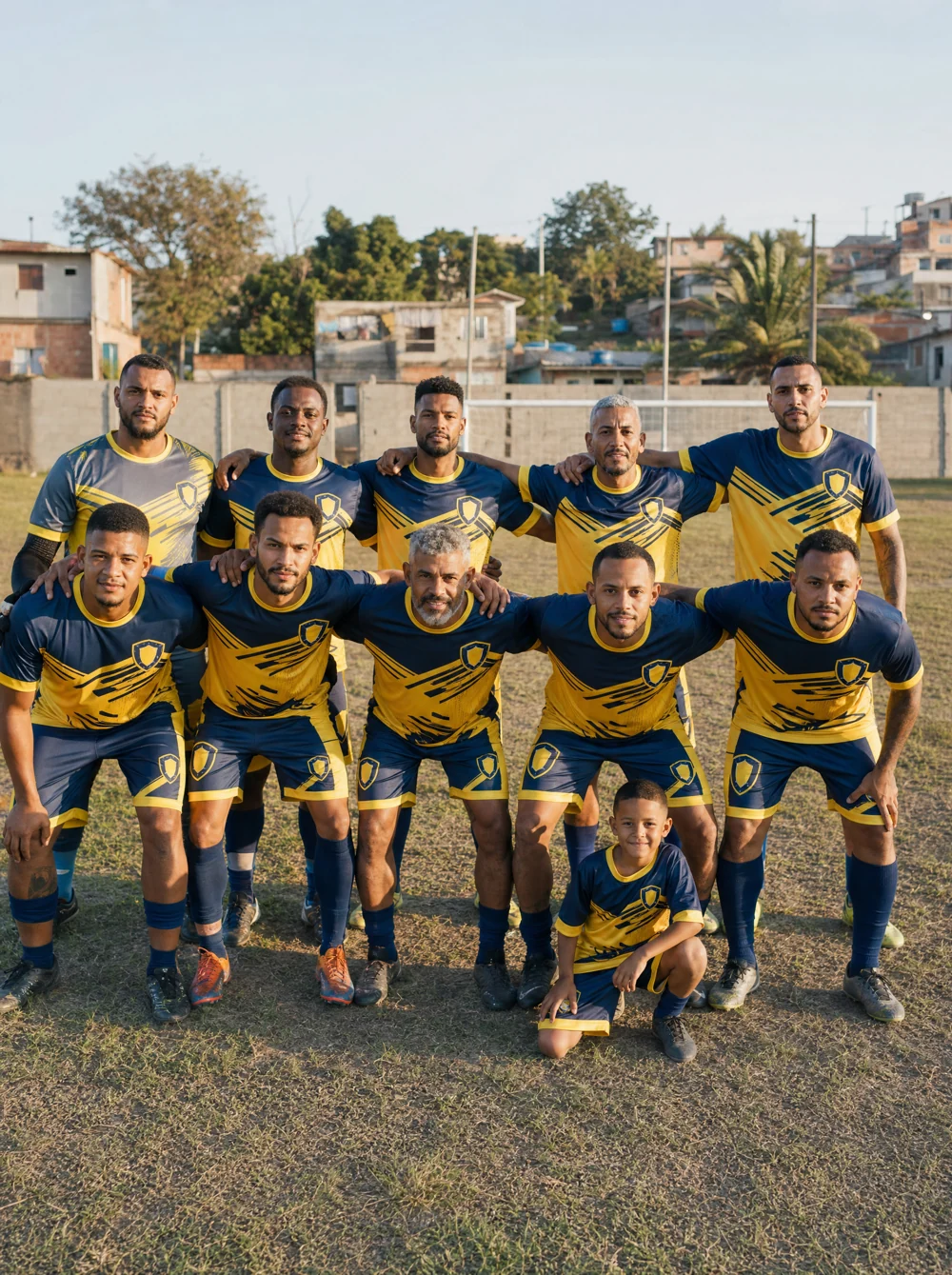 Time de várzea posando em campo de bairro com uniforme personalizado novo amarelo e azul